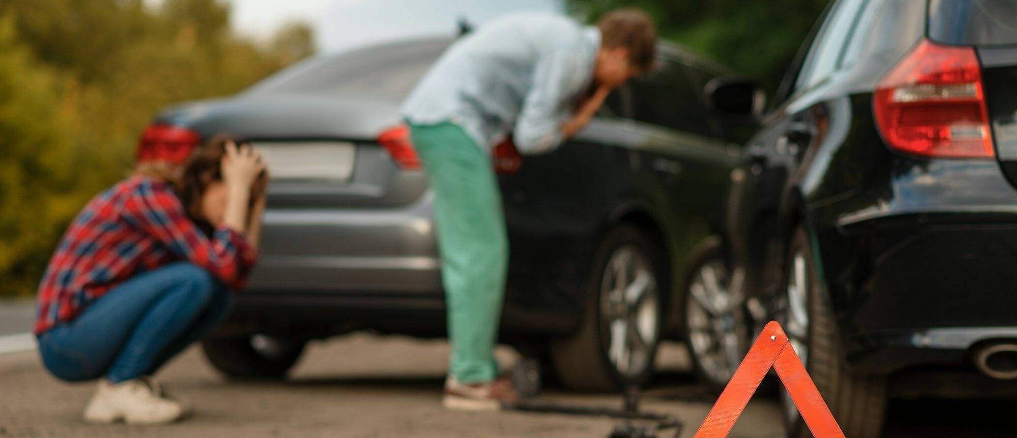 Car accident on road, male and female drivers