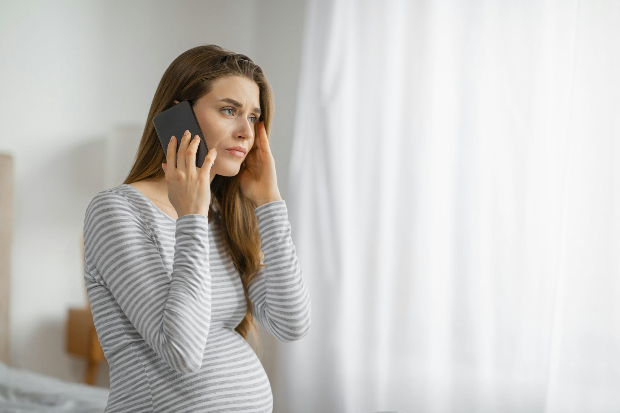 Concerned pregnant female on phone call